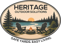 Heritage Outdoor Solutions — an oval badge showing two Adirondack chairs beside a fire pit on a lake shore, framed by pines, over the line “Safe Yards. Easy Living.”